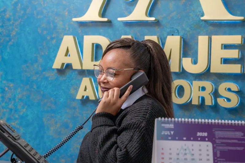 A member of the Adamjee Auditors team answering the phone at the Nairobi front desk