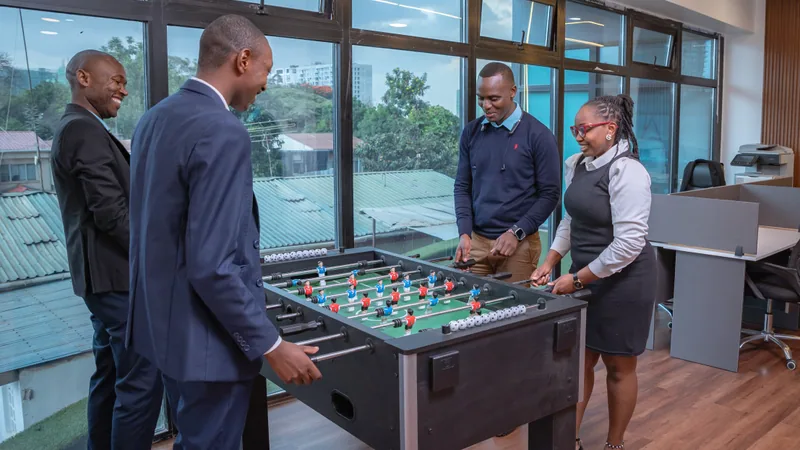 Adamjee Auditors colleagues playing table football in the Nairobi office